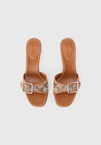 Tan leather slide sandals with a wide patterned strap featuring a snake print and a silver buckle. Smooth texture and open-toe design.