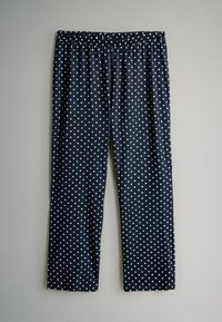 Marineblauwe, met stippen bedekte broek met een elastische tailleband, gemaakt van een zachte, lichtgewicht stof, voorzien van gelijkmatig verdeelde witte stippen.