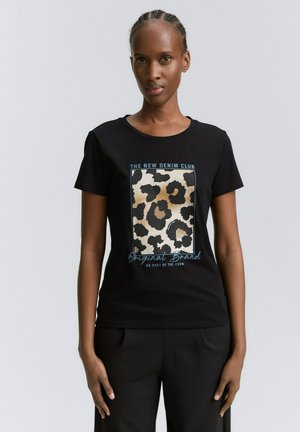 Schwarzes Baumwoll-T-Shirt mit einem Leopardenmuster in Beige und Braun, mit dem Text "The New Denim Club" in Blau. Kurze Ärmel und runder Halsausschnitt.