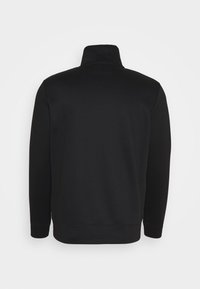 Svart långärmad tröja med hög krage, visad från baksidan mot en vit bakgrund.