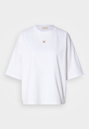 White cotton t-shirt with short sleeves, loose fit, and a small red and gold logo at the center. Simple and plain design.