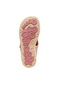 Podeszwa buta ma jasnobrązową bazę z różowymi gumowymi wzorami, w kształcie heksagonów i nieregularnych kształtów, zapewniającymi przyczepność. Miękka, teksturowana powierzchnia.