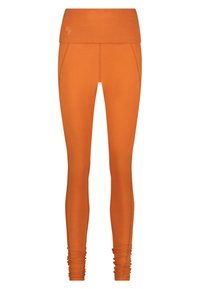 Orange leggings med en bred midjeresår. Slät, elastisk tyg. Samlad detalj vid ankeln. Diskret logotyp på midjeresåren.