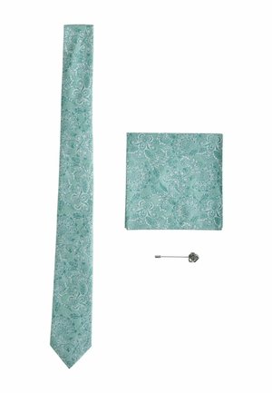 Light teal floral patterned necktie, matching pocket square, and silver flower lapel pin arranged on white background.