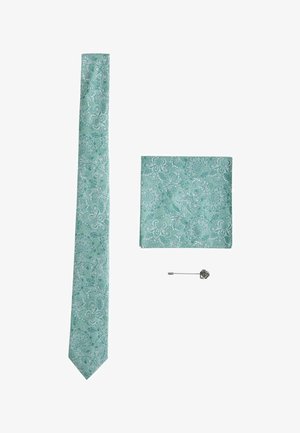 Light teal floral patterned necktie, matching pocket square, and silver flower lapel pin arranged on white background.