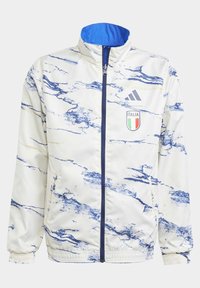 Adidas-jacka i vitt med blå marmorering, ståkrage, framdragkedja och Italienmärke på vänster bröst. Elastiska ärmslut och nederkant.