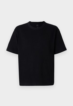 Camiseta de algodón negra con cuello redondo, mangas cortas y corte recto. Presenta costuras minimalistas y una textura suave y lisa.
