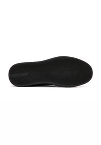 Suola nera di scarpa con un design in gomma testurizzata, caratterizzata da una forma arrotondata e una banda accentuata sottile vicino al tallone.