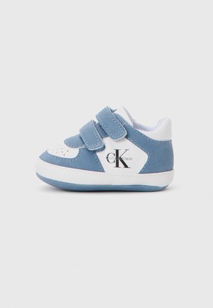 Blue suede children's sneakers with white accents, dual Velcro straps, and a logo on the side. Rounded toe and textured sole.