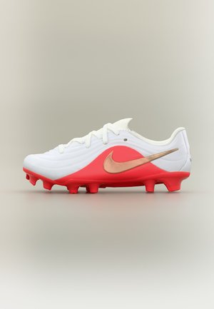 Άσπρο και κόκκινο ποδοσφαιρικό παπούτσι Nike με χάλκινο λογότυπο Swoosh και καλουπωμένα τάπες σε ουδέτερο φόντο, πλάγια όψη.