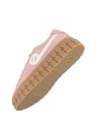 Pink canvas sneaker with a white logo, laces, and a textured gum rubber sole featuring a hexagonal pattern.