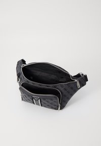 Black fabric crossbody bag with multiple zippered compartments, featuring a logo accent and striped detailing. Smooth texture and structured design.