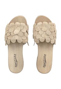 Beige suede slide sandals with circular accents, wooden insoles, and a smooth finish. Open-toe design with a soft, textured upper.