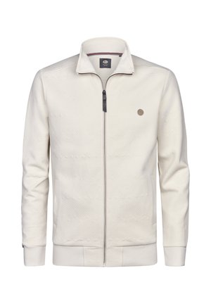 Chaqueta para hombre con cremallera en color crema claro. Patrón texturizado con líneas diagonales, cremallera oscura en contraste y detalle de logo en el pecho. Manga larga.