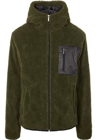 Oliwkowa polarowa kurtka z zamkiem błyskawicznym z przodu, kapturem oraz czarną nylonową kieszenią na piersi. Posiada pluszową teksturę i elastyczne mankiety.