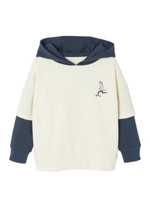Cream-colored sweatshirt with a navy blue hood and sleeves. Features a skateboarding graphic on the chest. Soft fabric and relaxed fit.