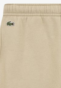 Lacoste CORE PANT UNISEX - Treniņtērpa apakšdaļas - beige