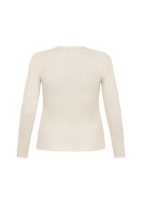 Helles beige Langarmoberteil aus weichem Stoff, mit verstreuten silbernen Pailletten. Einfaches Design, runder Ausschnitt, figurbetonte Silhouette.