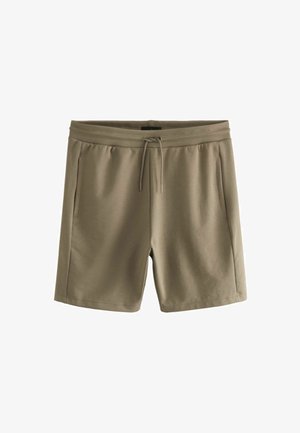 Pantalones cortos de color marrón claro hechos de una tela suave, con una cinturilla elástica con cordón y dos bolsillos laterales. Diseño simple y funcional.