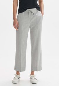 Light grey, wide-leg trousers made of textured fabric. Features an elastic waistband with drawstring and subtle cuffs at the ankles.