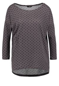 Graues Langarmshirt mit schwarzen Pünktchen, rundem Ausschnitt und leicht abgerundetem Saum. Aus weichem, atmungsaktivem Stoff gefertigt.