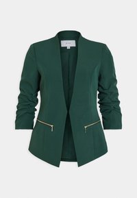 Grön kavaj med en strukturerad design, med rynkade ärmar, två fickor med dragkedja och en kraglös halsringning. Slät textur.