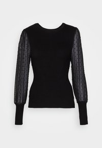 Maglione nero a maglia con lunghe maniche trasparenti, caratterizzato da polka dot testurizzati, scollatura rotonda e silhouette aderente.