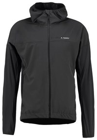 Svart dragkedjeförsedd jacka med huva, tillverkad av lättviktsmaterial. Har en kontrasterande logotyp på bröstet samt elastiska muddar och nederkant.