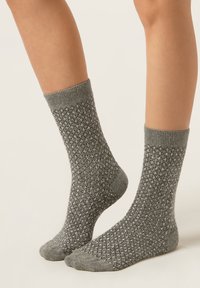 Gray knit socks with a textured pattern and ribbed cuffs, featuring a reinforced toe and heel. Suitable for casual wear.