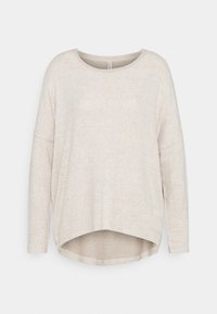 Chemise longue beige clair à manches longues avec un col large et un ourlet courbé. Texture douce et coupe décontractée, avec des coutures d'épaule tombantes.