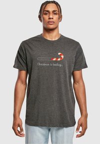 Gray short-sleeve T-shirt featuring a candy cane graphic and the text "Christmas is loading..." in white, smooth cotton blend fabric.