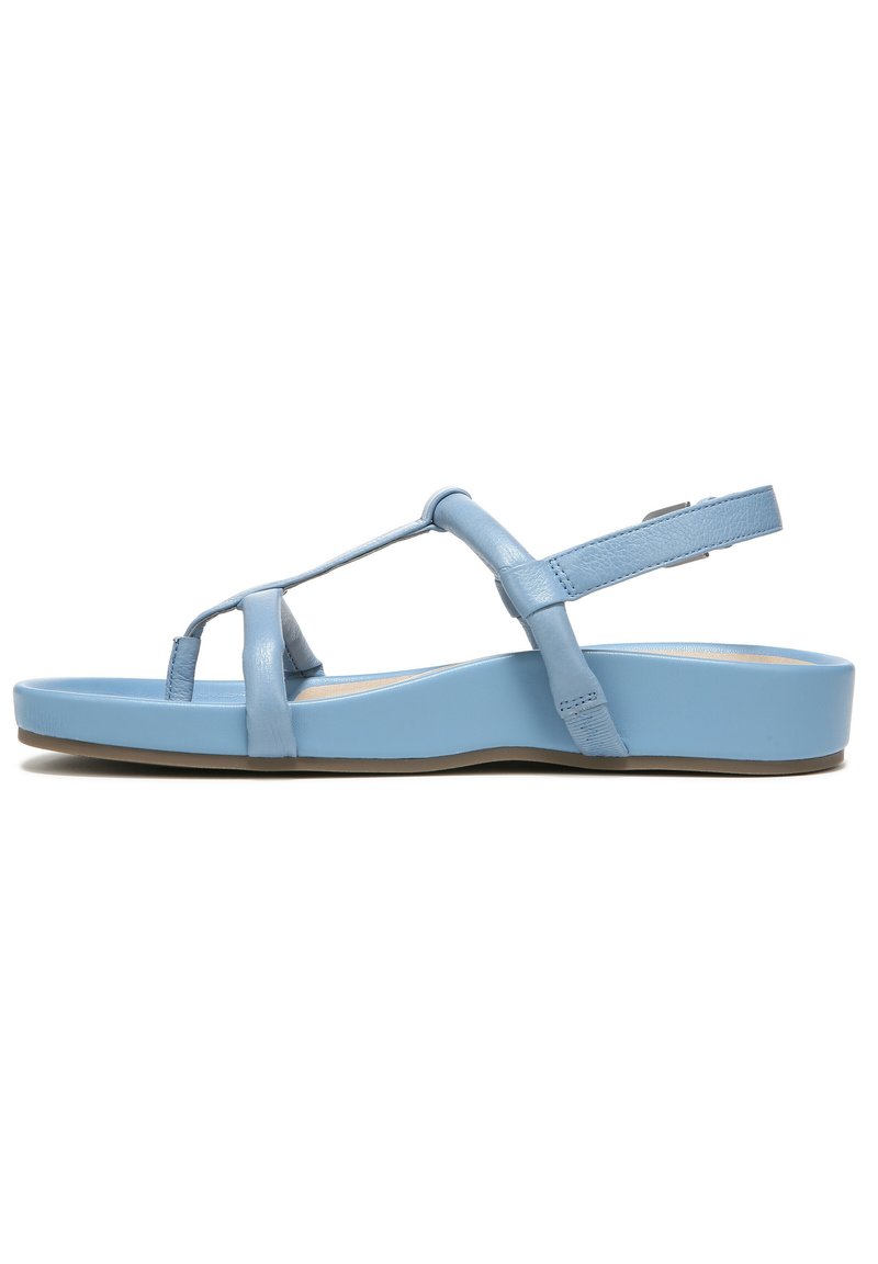 Light blue leather sandals with a flat sole, featuring a T-strap design, ankle strap, and a smooth, shiny texture.