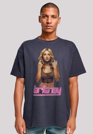 Black cotton T-shirt featuring a graphic of a woman with long hair, wearing a brown top, with the name "britney" in pink text below.