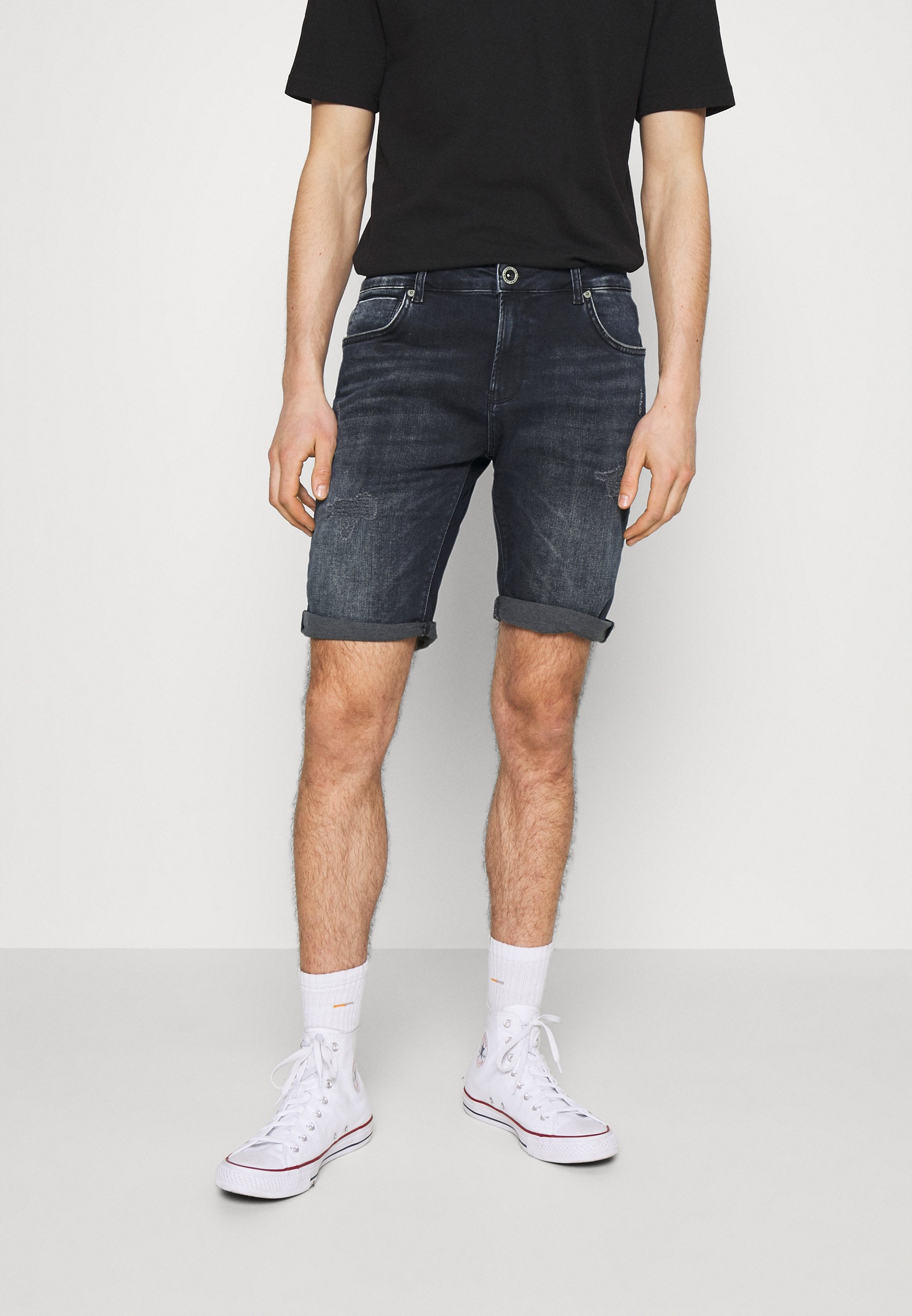 damaged denim shorts