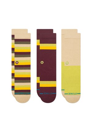 Three pairs of socks: one with multicolored stripes on beige, one in burgundy with yellow accents, and one solid light green with beige.