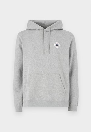 Grauer Kapuzenpullover mit einer Fronttasche, gerippten Bündchen und einem runden Logo mit einem Stern. Hergestellt aus weichem Stoff mit glatter Textur.