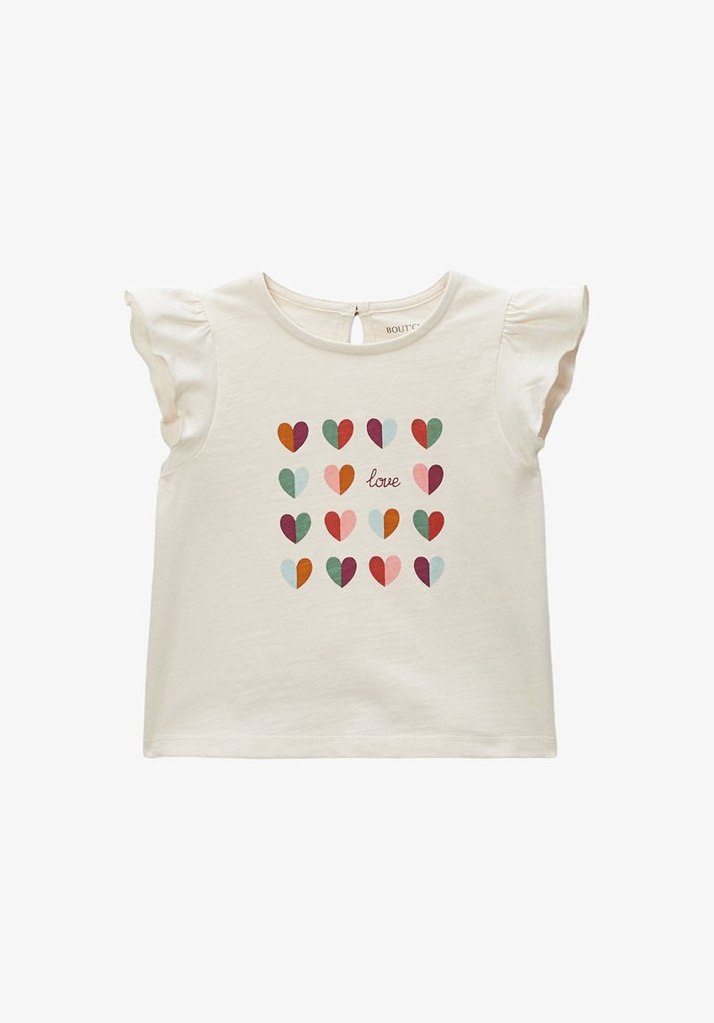 T-shirt crème à manches courtes avec épaules volantées, arborant un motif de cœurs multicolores et le mot « love » au centre.