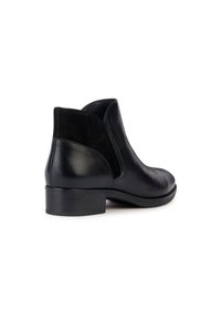 Stivale alla caviglia in pelle nera con tacco basso, dettagli in suede nero texture sui lati e design slanciato.