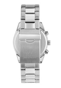 Orologio in acciaio inossidabile argentato con bracciale a maglie, cassa rotonda e corona testurizzata. Presenta un logo inciso sulla chiusura.