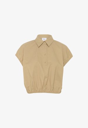 Bēžs īsām piedurknēm krekls ar apkakles kakla izgriezumu, pogu priekšu un elastīgu apakšmalu. Izgatavots no mīksta auduma ar gludu tekstūru.