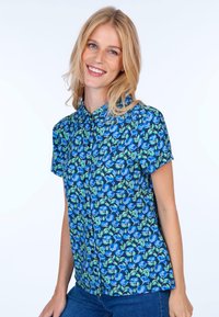 Short-sleeve blouse in blue with a floral pattern featuring blue flowers and green leaves on a dark background. Button-down design.