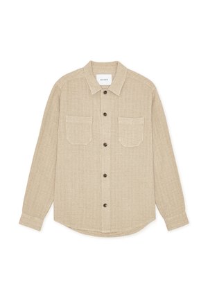 Beige button-up shirt made of textured fabric with a collar, two front pockets, and brown buttons. Straight hem and long sleeves.