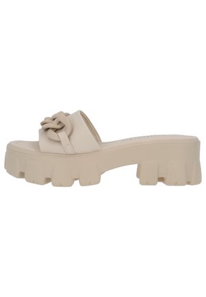 Beige platform slide sandal med en tyk, tekstureret sål og en knyttet remdetalje. Glat materiale med et minimalistisk design.