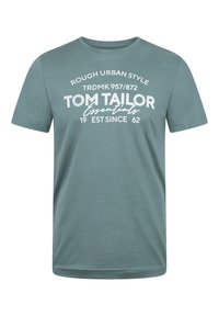 Camiseta de algodón verde con cuello redondo. Presenta texto impreso en blanco "ROUGH URBAN STYLE TOM TAILOR Essentials 1962" en varias tipografías.