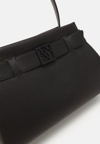 Schwarze Handtasche aus glattem synthetischem Material, mit einer strukturierten Form, einem flachen Riemen und einem rechteckigen Verschluss mit Logodetails.