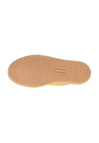 Semelle de chaussure en matériau caoutchouteux beige, dotée de rainures horizontales pour une traction optimale et d'un marquage en relief. Design solide et fonctionnel.