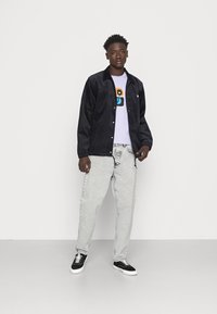 Carhartt WIP NEWEL PANT - Calças de ganga de corte afunilado - black sun washed