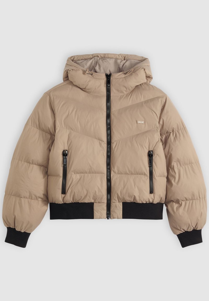 Giacca imbottita beige con cappuccio, dotata di una zip frontale, due tasche laterali con zip e polsini e orlo a coste neri. Motivo a rombi trapuntato.