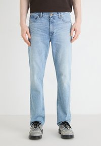 Light blue denim jeans with a straight fit, classic five-pocket design, and a zip fly. Soft texture with slight fading on the legs.