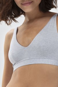 Bralette grigia senza cuciture con scollatura a V e spalline larghe. Tessuto morbido e testurizzato con una fascia di supporto sotto il busto.